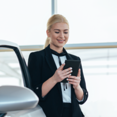 A sales women in a dealership using CitNOW conversations on a mobile device